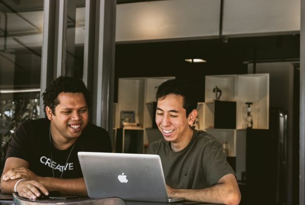 Business owners using their laptop and smiling