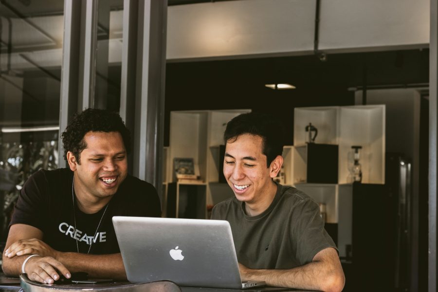 Business owners using their laptop and smiling