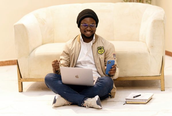 Man sitting on the floor testing his low code/no code business app with gen AI features