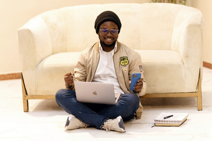 Man sitting on the floor testing his low code/no code business app with gen AI features