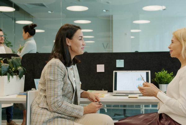 Two women in a small business use decision intelligence tool in a meeting to make the right choices